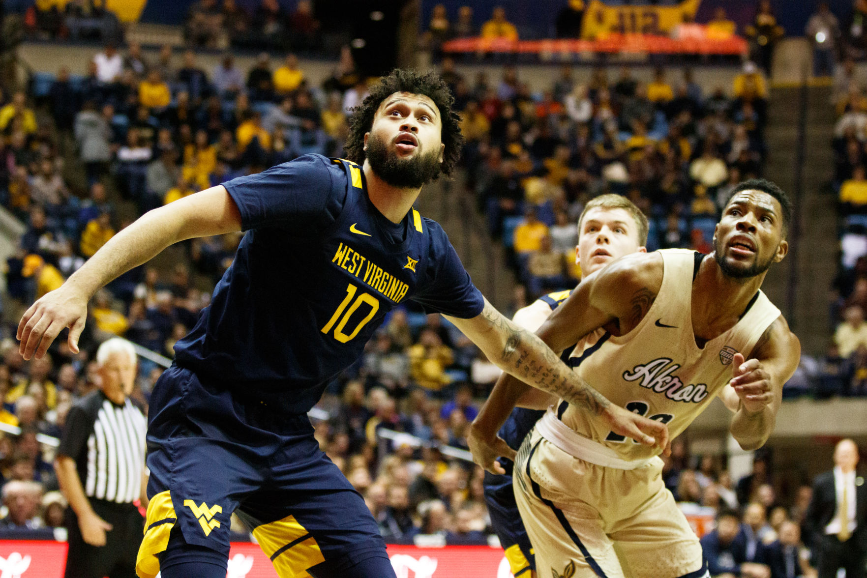 West Virginia's Jermaine Haley and Akron's Xeyrius Williams fight for a loose rebound during West Virginia's season opener against Akron on Nov. 8, 2019 at the WVU Coliseum.